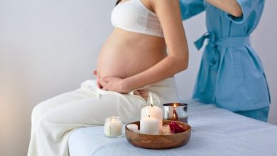 cropped-female-physiotherapist-massaging-back-shoulders-pregnant-woman-sitting-bed-bright-spa-cabinet-with-candles-adult-mom-be-is-enjoying-getting-massage_183219-7931-1556404