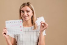 fake-smiling-woman-holding-period-calendar-pads_23-2148381555-4472759