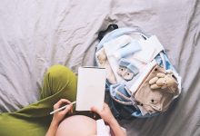 pregnant-woman-packing-hospital-bag-with-checklist_494619-111-8918877